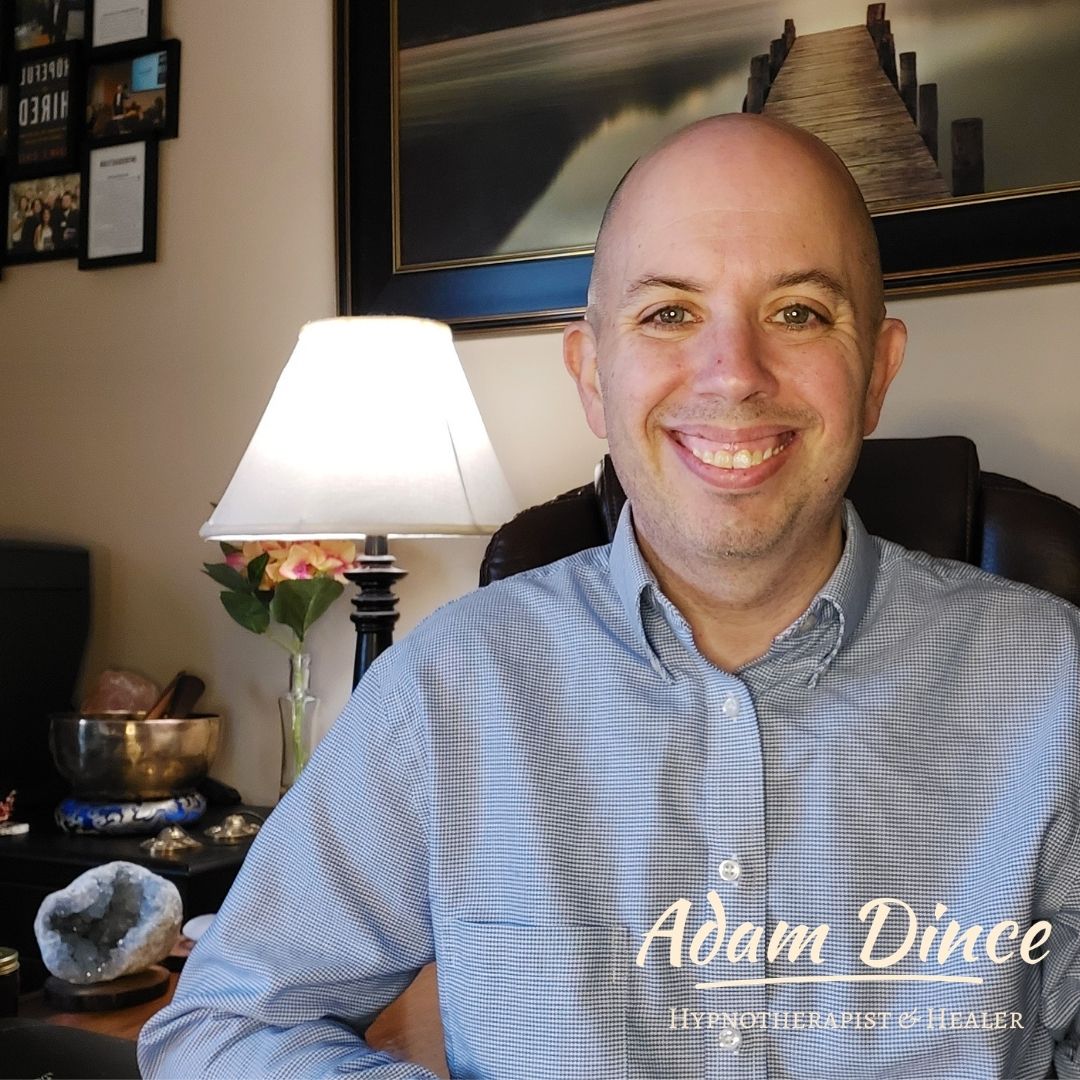 Adam Dince smiling in his hypnotherapy office